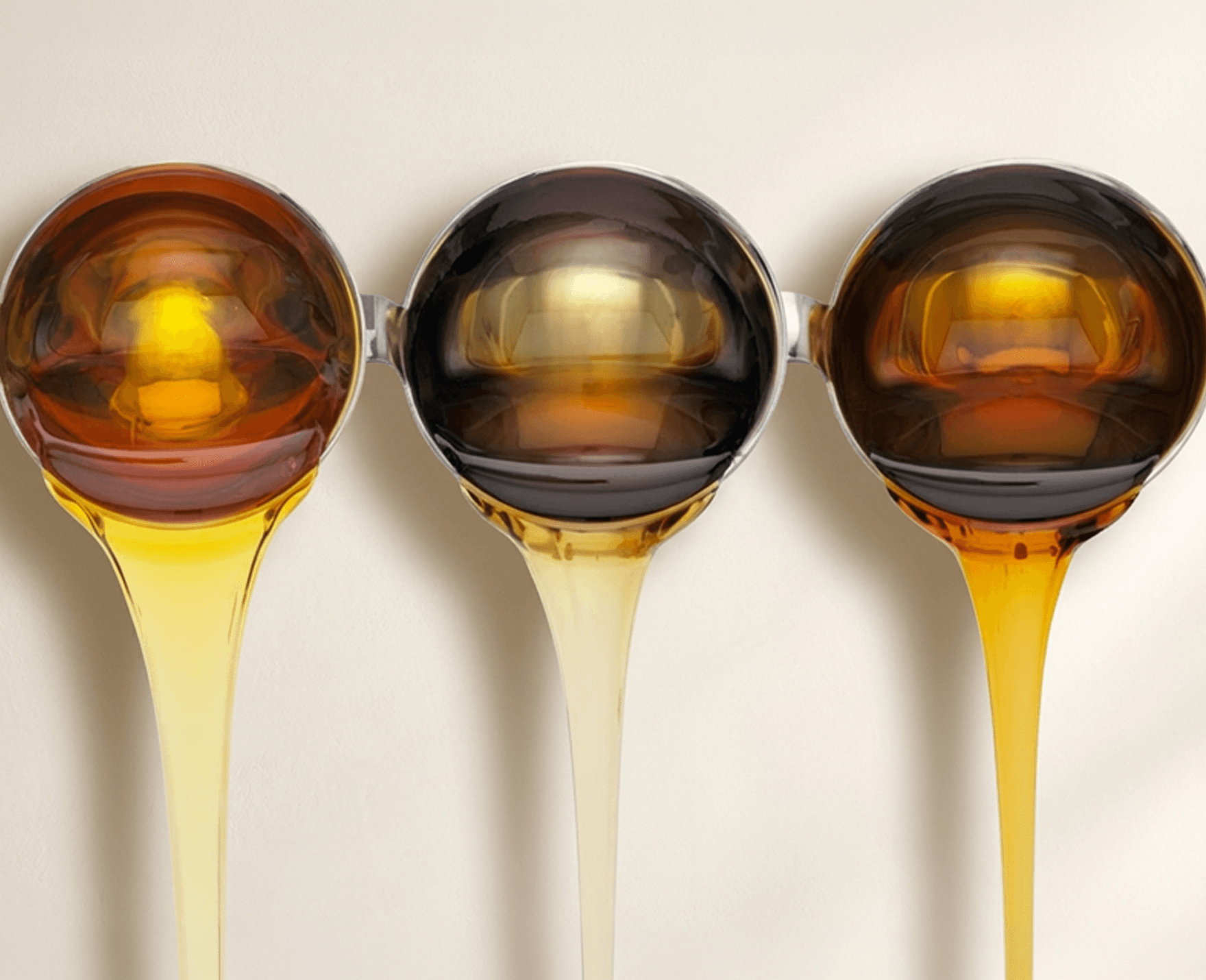 Refined liquid sugar products in varying amber tones, representing U.S. Sugar’s processing and product offerings.